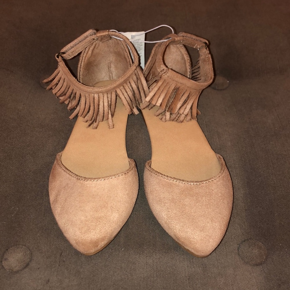 Girls flats with fringed ankle detail.